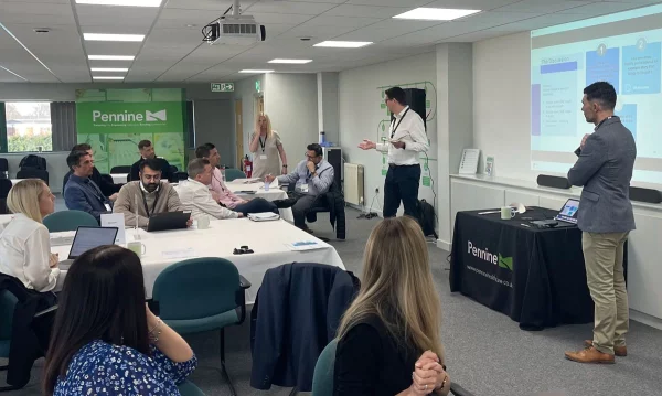 Group of professionals sat listening to presentation